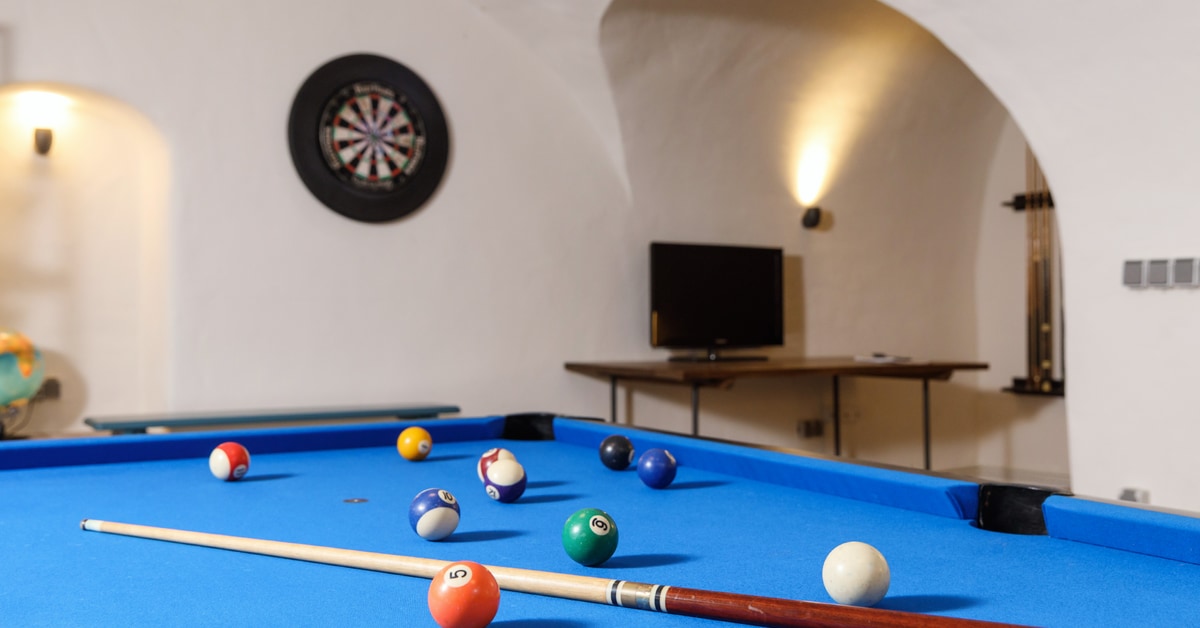 Sanierter Keller mit blauem Billardtisch als Freizeitraum